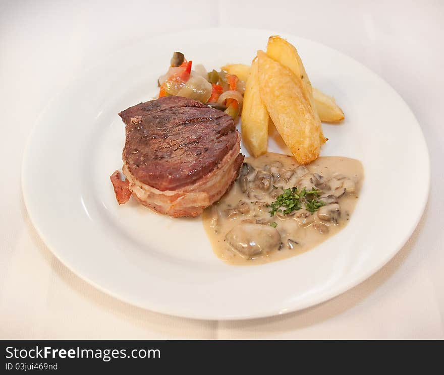 Tasty steak with potato and grilled vegetables. Tasty steak with potato and grilled vegetables