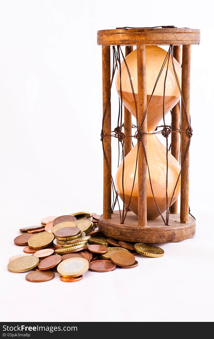 Old hourglass (made in India, XIX century) with euros. Old hourglass (made in India, XIX century) with euros