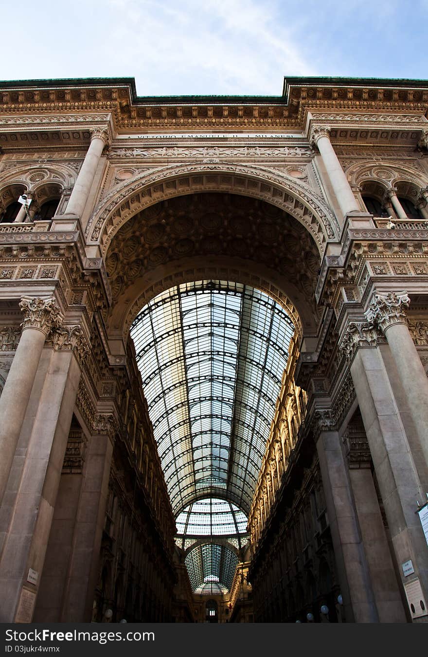 The Galleria Vittorio Emanuele II is a covered double arcade formed of two glass-vaulted arcades at right angles intersecting in an octagon, prominently sited on the northern side of the Piazza del Duomo in Milan. The Galleria Vittorio Emanuele II is a covered double arcade formed of two glass-vaulted arcades at right angles intersecting in an octagon, prominently sited on the northern side of the Piazza del Duomo in Milan.