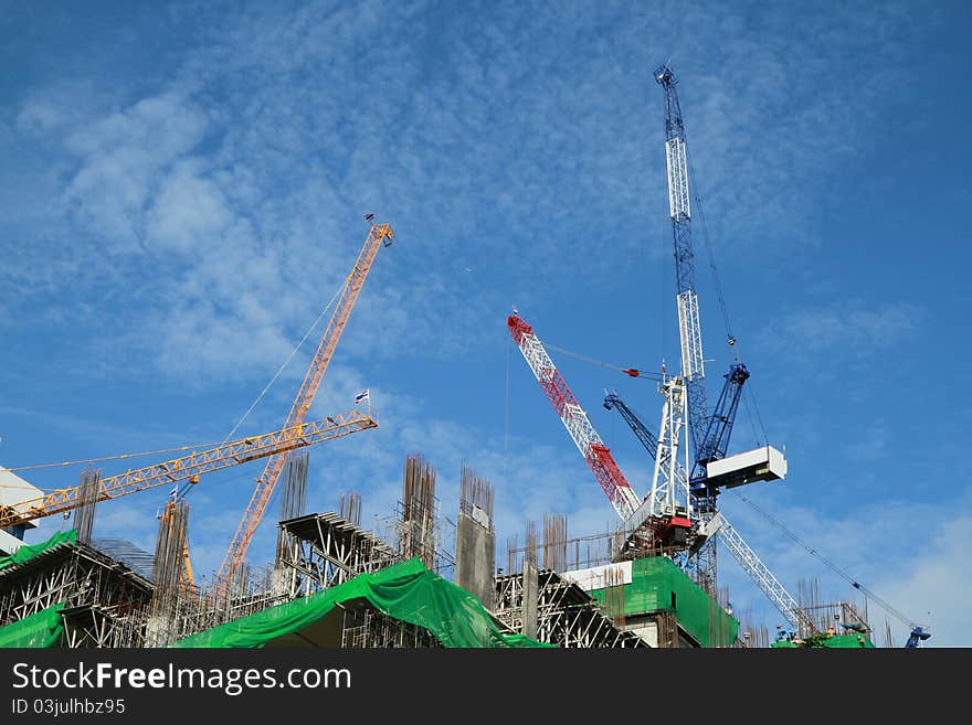 Crane and building construction on blue background