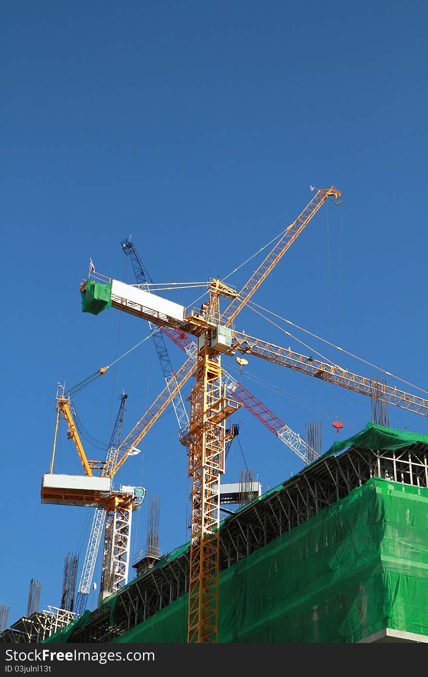 Crane and building construction on blue background