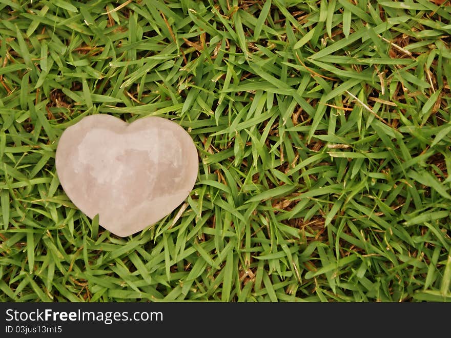 Pink heart on green grass. Pink heart on green grass