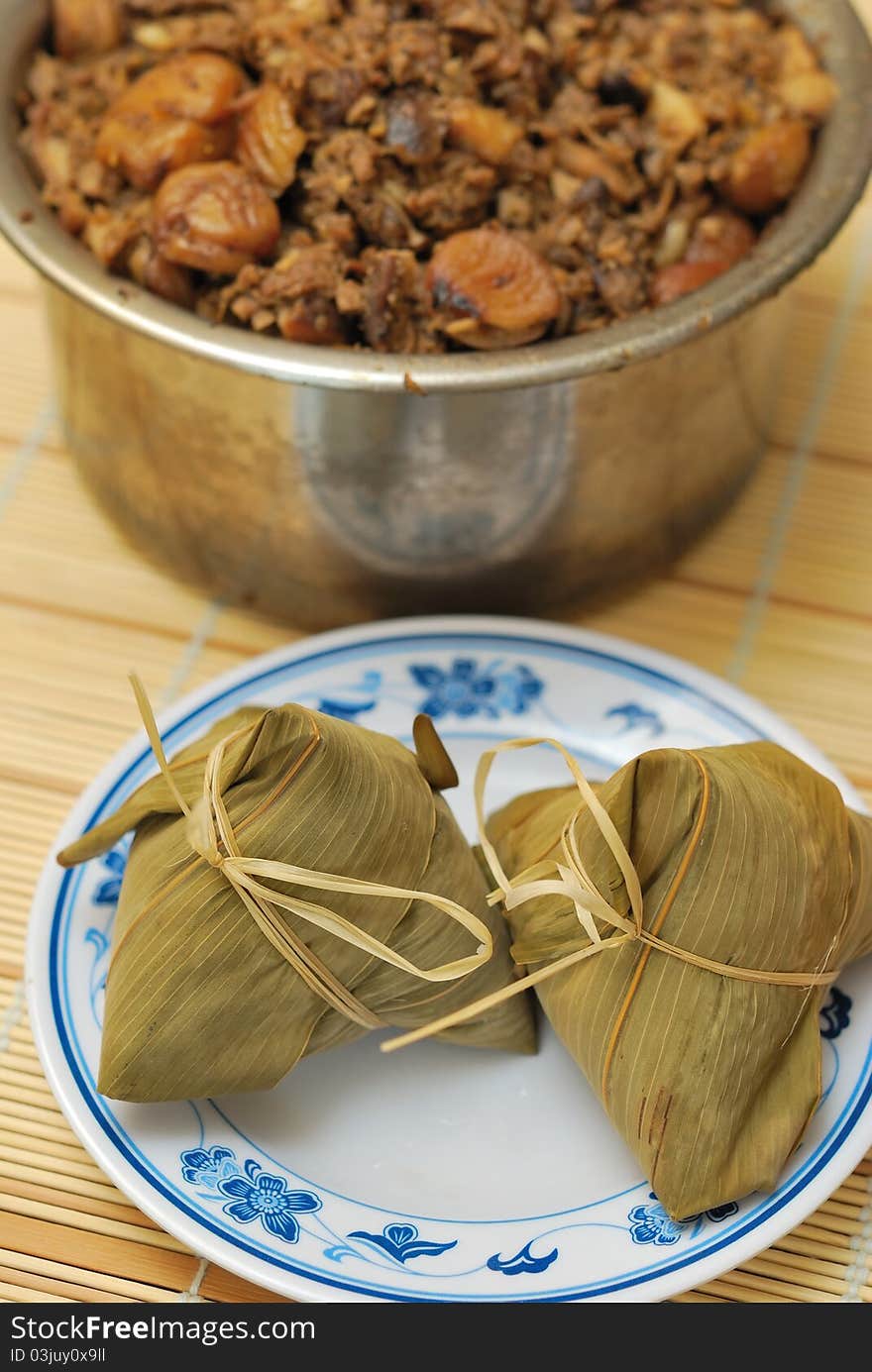 Sumptuous traditional delicacy of bamboo wrapped meat dumplings on plate. Sumptuous traditional delicacy of bamboo wrapped meat dumplings on plate.