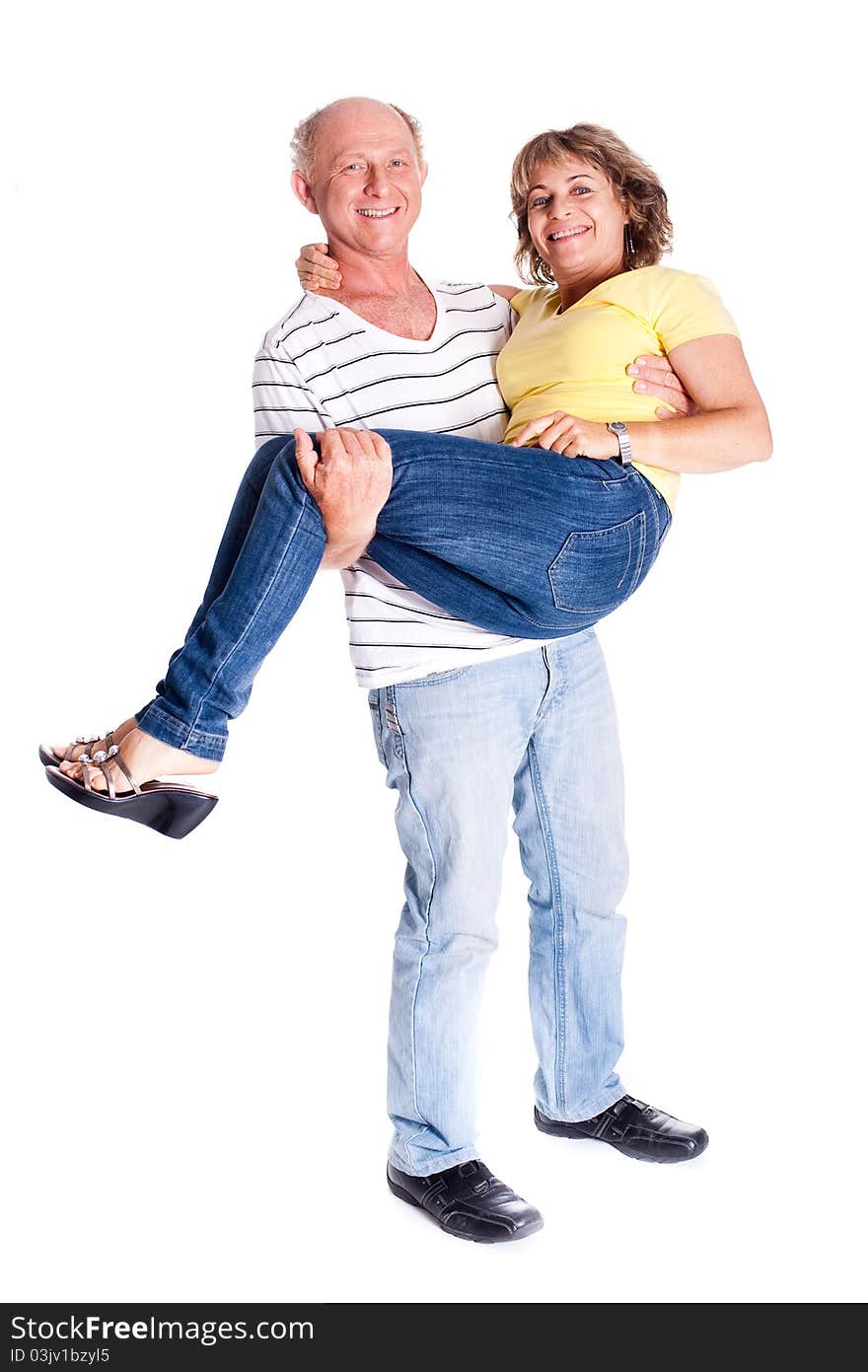 Playful senior couple having fun indoors isolated over white background...