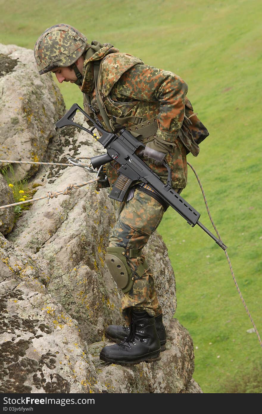 Military man does dangerous rappeling in combative ammunition. Military man does dangerous rappeling in combative ammunition