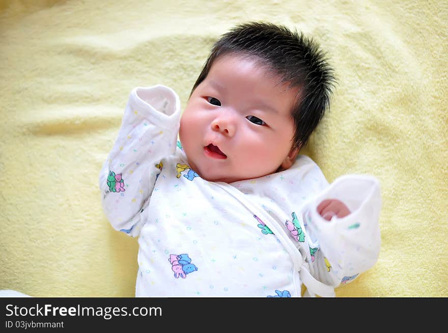 A 2 months chinese Baby girl lying on the bed. A 2 months chinese Baby girl lying on the bed