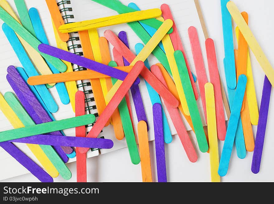 They are colorful of wood on notebook.