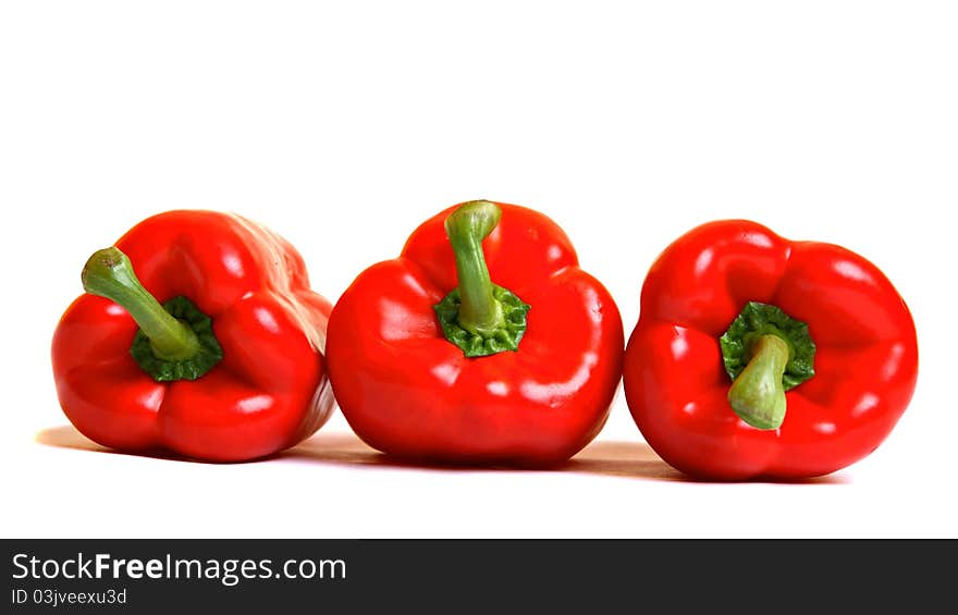 Three red peppers, isolated on white