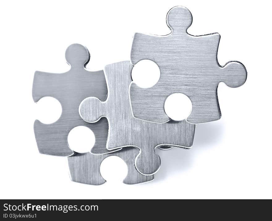 Stainless steel puzzle pieces on white background with space for text