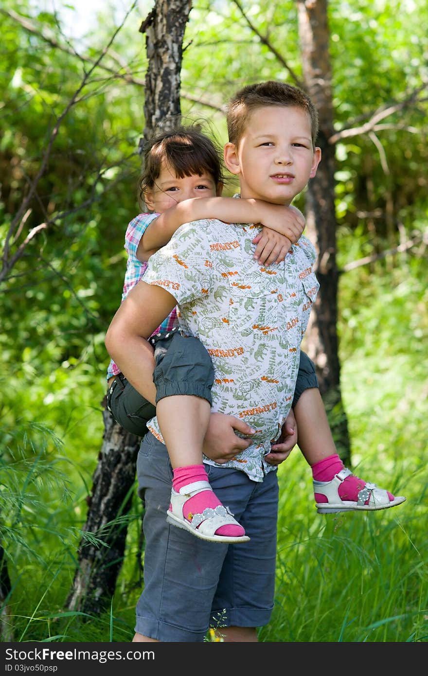 The big brother rolls the sister on a back. The big brother rolls the sister on a back