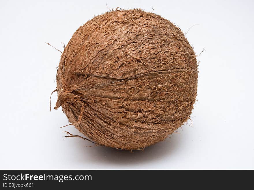 One tropical coconut in husk, isolated on white background. One tropical coconut in husk, isolated on white background.