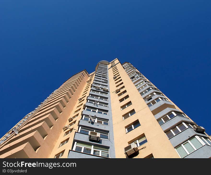 Dwellings house in town on a background blue sky. The bottom foreshortening