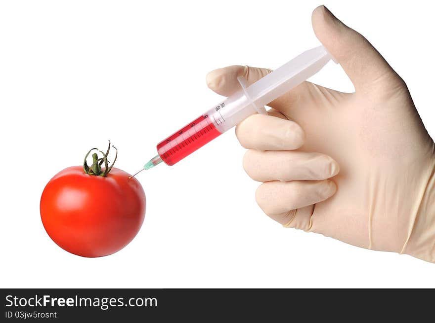 Hand with syringe make injection to tomato