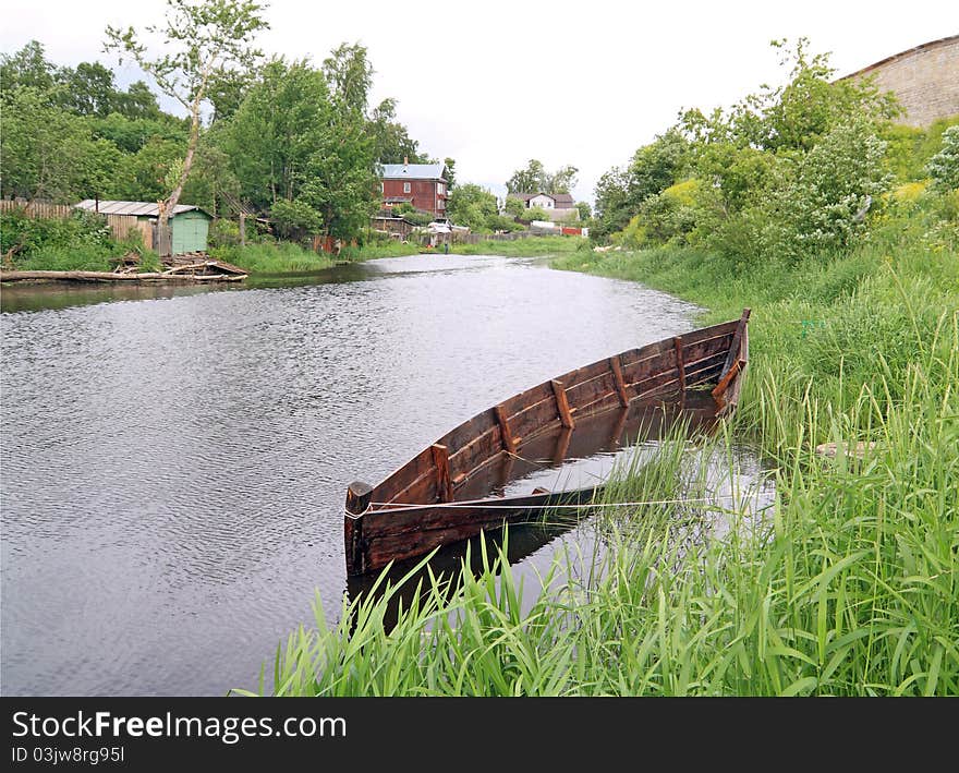 Aging drowned boat on river