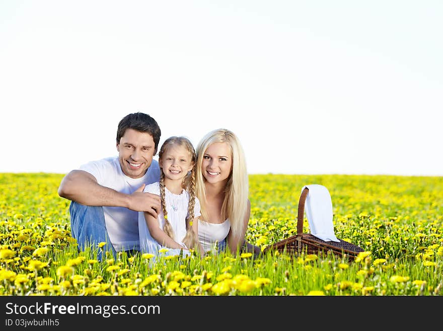 Happy young family in the dandelion field. Happy young family in the dandelion field