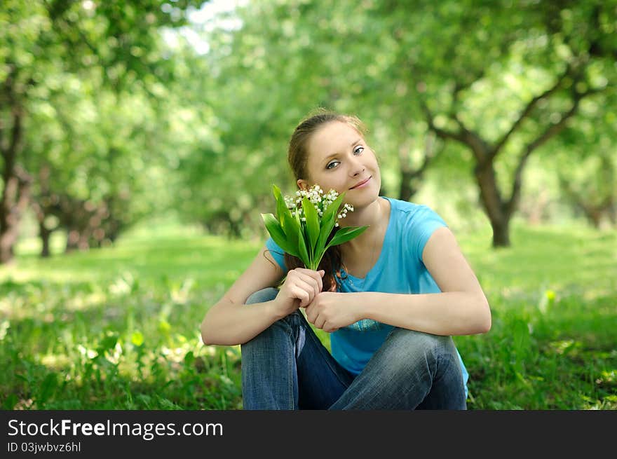 Young woman in the park with flowers. Young woman in the park with flowers