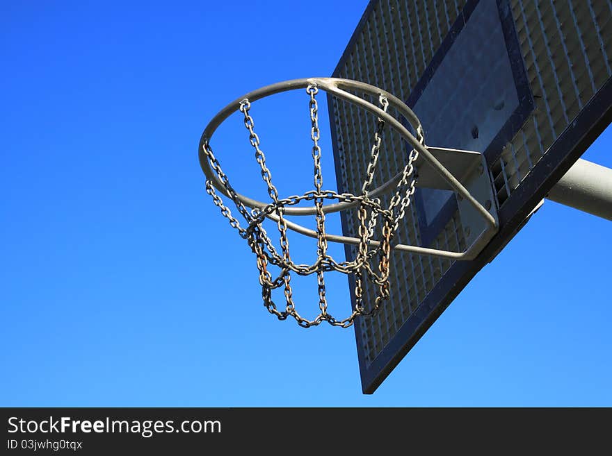 A basketball ring over a blue sky. A basketball ring over a blue sky