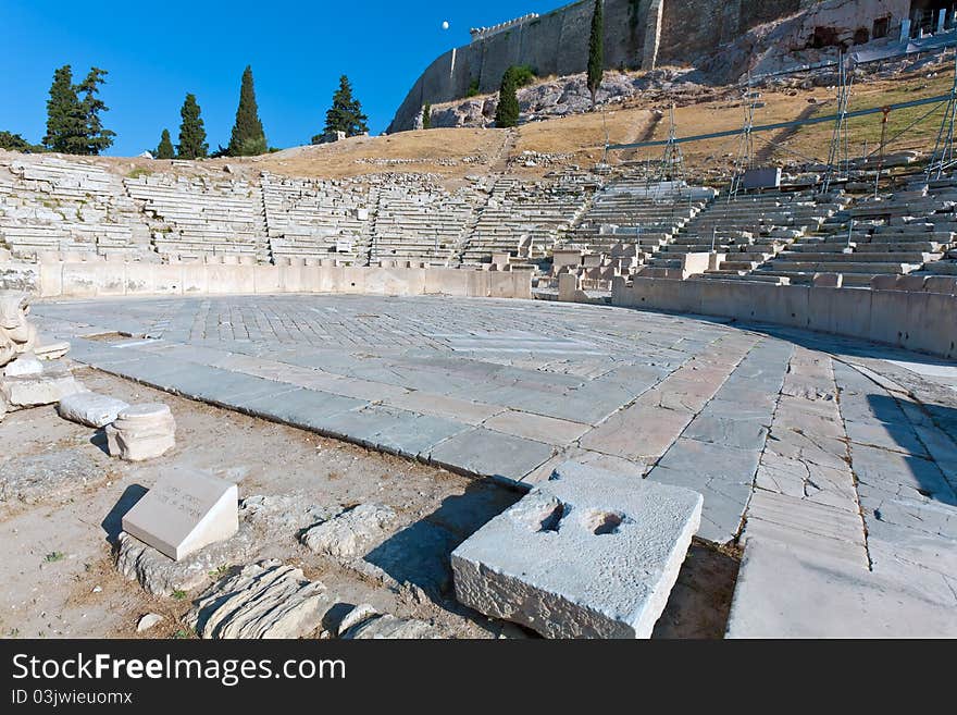 Wide-angle, no people, sunlit view of Theater of Dionysos, Acropolis, Athens, Greece