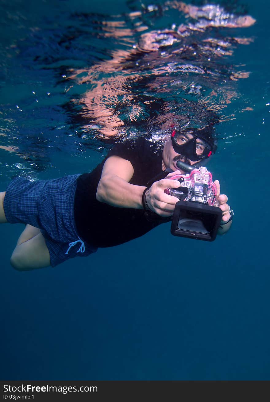 Snorkeling free-diver with camera, Maldives