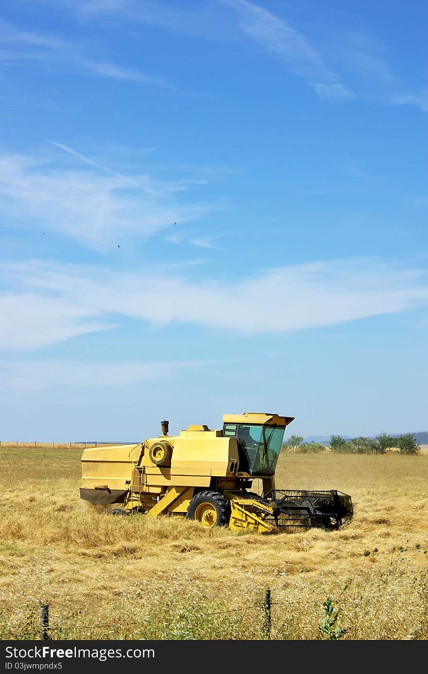 Combine harvester working a wheat field at Portugal. Combine harvester working a wheat field at Portugal.