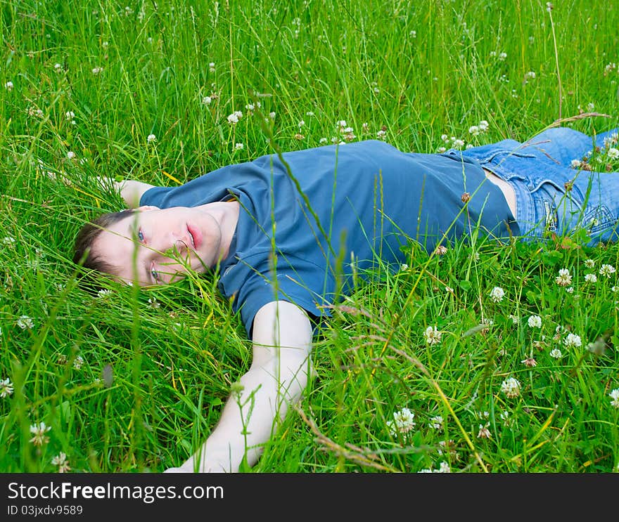 The Young Man Lies On A Green Grass