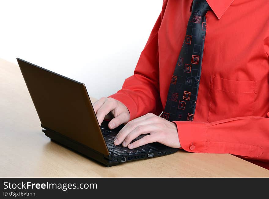 Student dressed in a red shirt, working on laptop. Student dressed in a red shirt, working on laptop