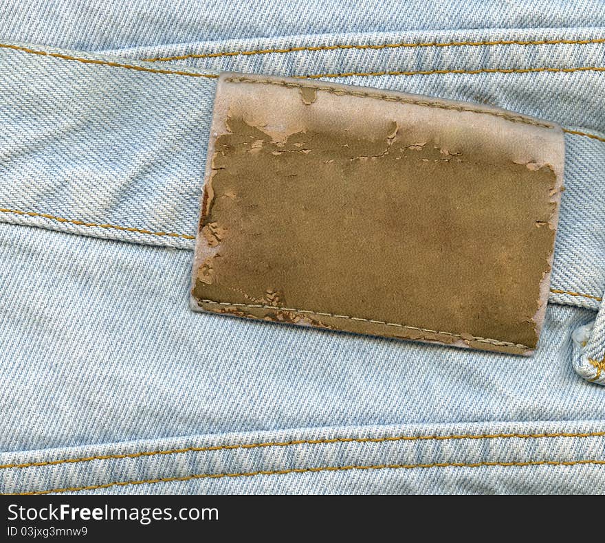 Blank leather label on blue jeans