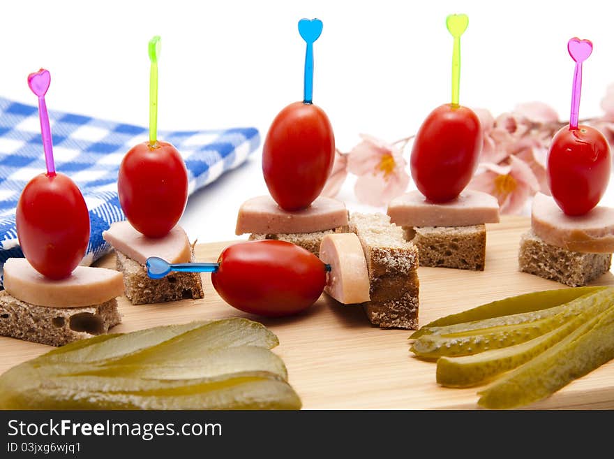 Tomato and sausage with bread on spit. Tomato and sausage with bread on spit