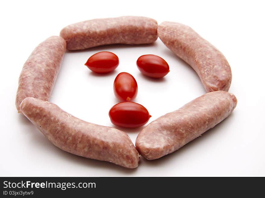 Coarse fried sausage with tomato onto white background