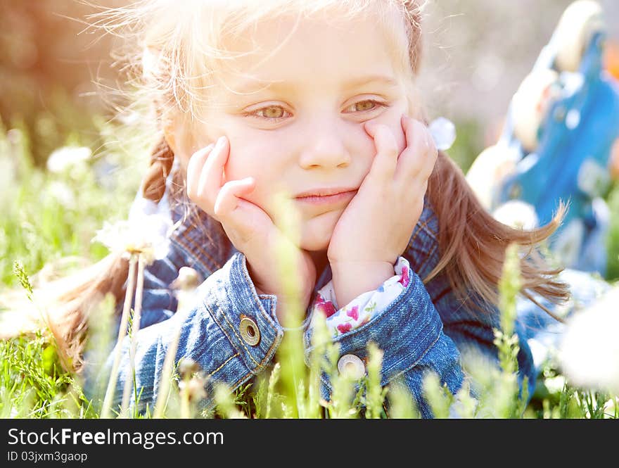 Cute little girl smiling in a park close-up