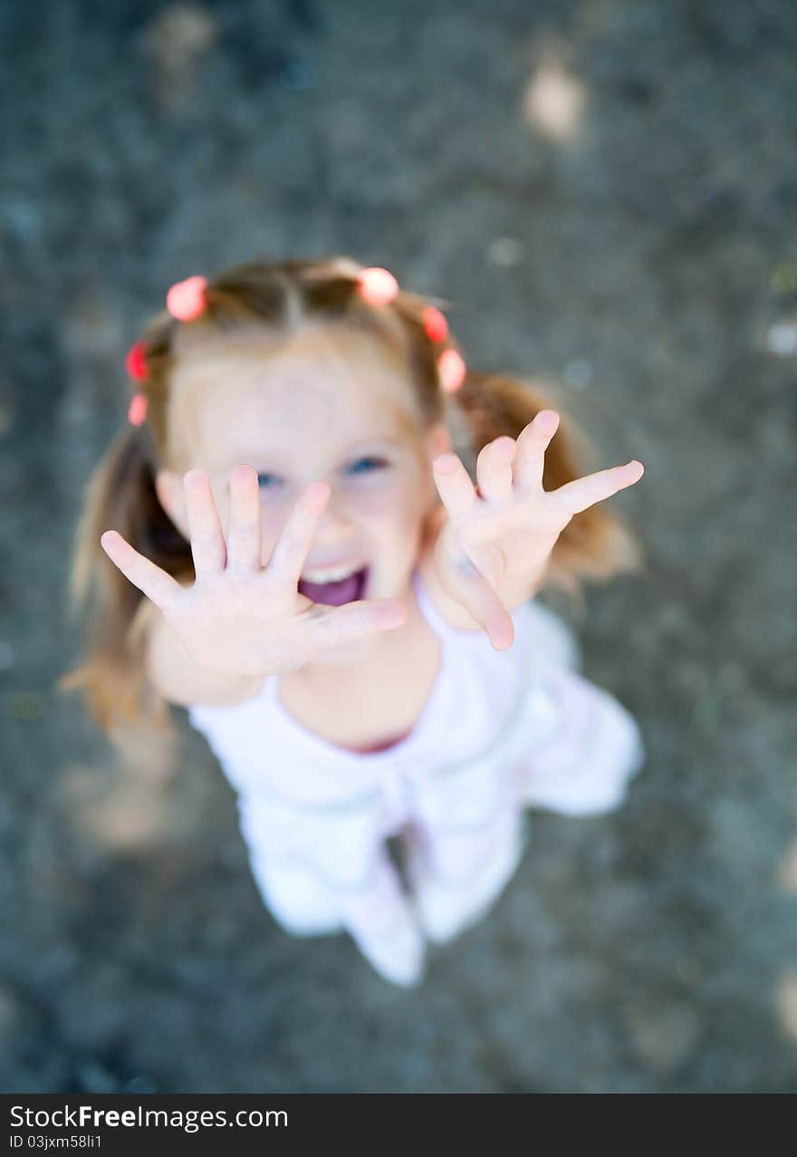 Cute little girl smiling in a park close-up