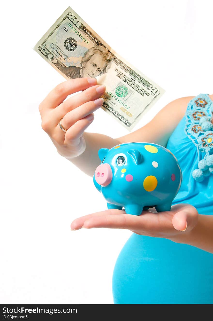 Pregnant woman with a piggy bank