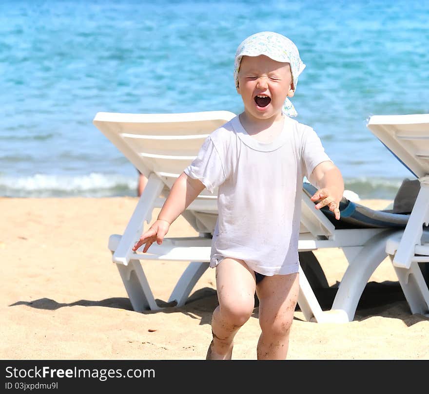 The admired boy running on coast. The admired boy running on coast