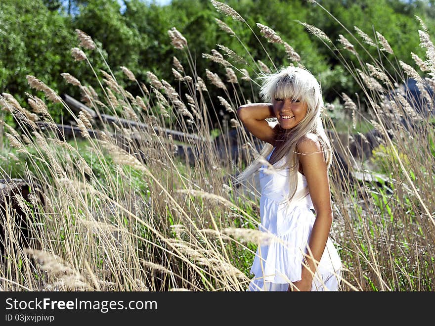 Girl are standing in dry grass