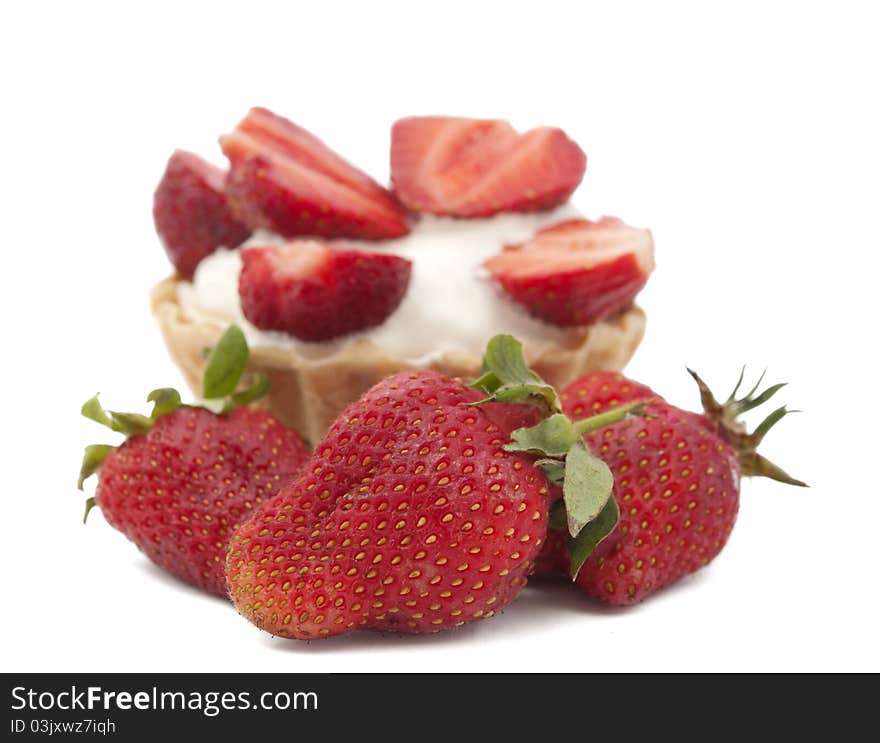 Strawberries and cream in a basket on a white background