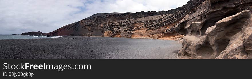 Panoramic view of charco de los clicos, black beach in el golfo, lanzarote, canary islands