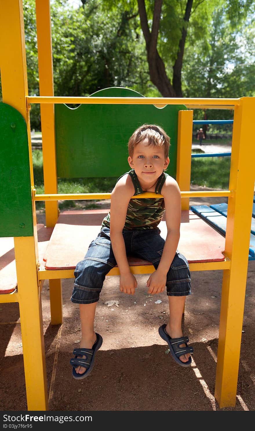 Cute young boy playing on playground. Cute young boy playing on playground