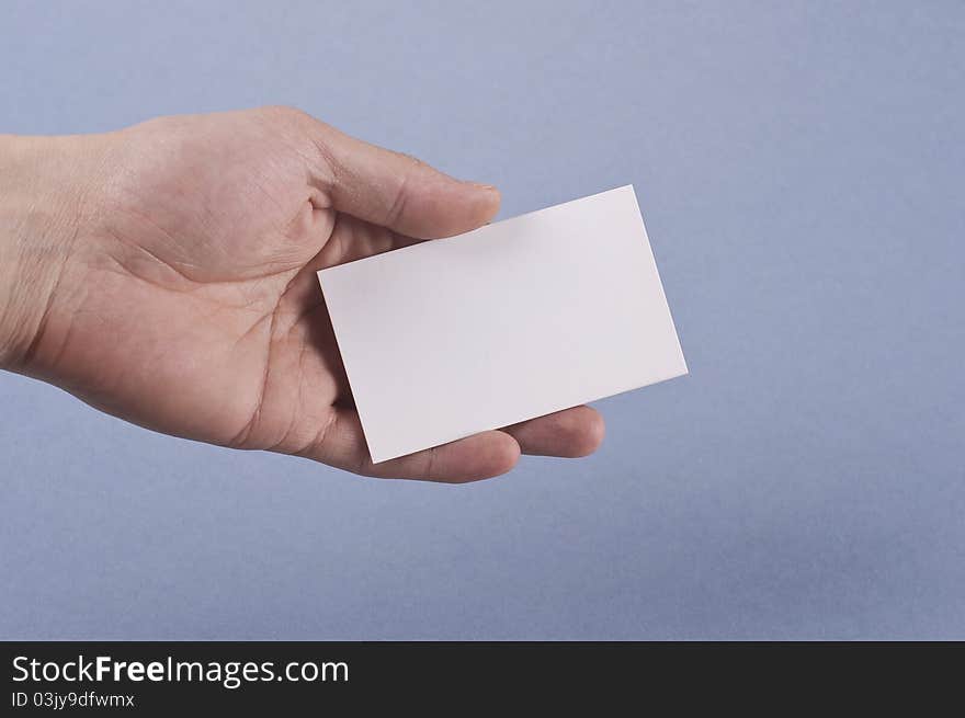 Blank business card in elegant male hand on blue background Isolated. Blank business card in elegant male hand on blue background Isolated.