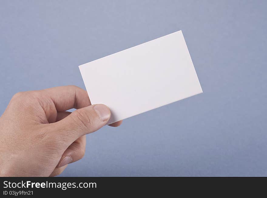 Blank business card in elegant male hand on blue background Isolated. Blank business card in elegant male hand on blue background Isolated.