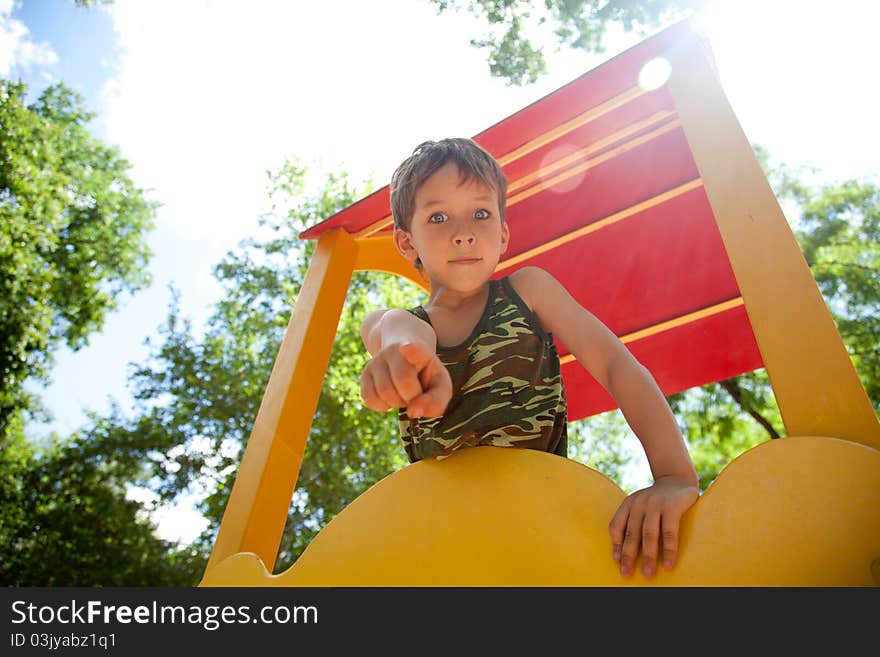 Cute young boy playing on playground. Cute young boy playing on playground