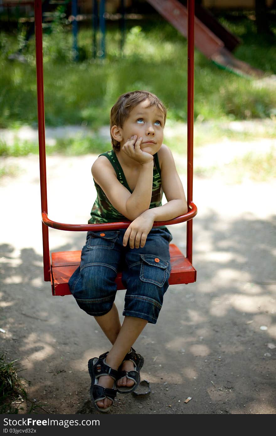 Little boy swinging on a swing. Little boy swinging on a swing