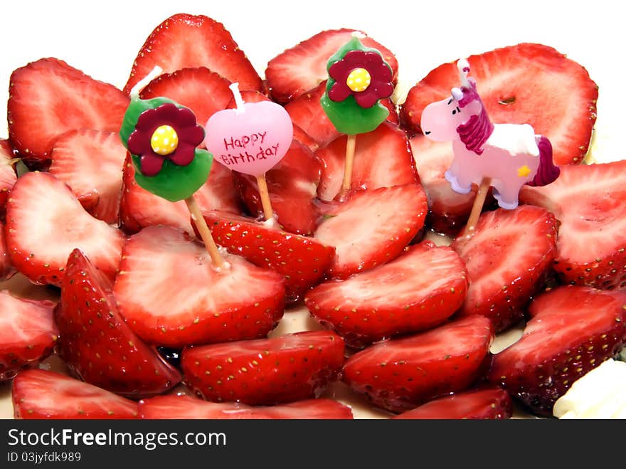 Four childish candles on a strawberry birthday cake, nobody, isolated over white, brightly lit, copyspace, copy space. Four childish candles on a strawberry birthday cake, nobody, isolated over white, brightly lit, copyspace, copy space