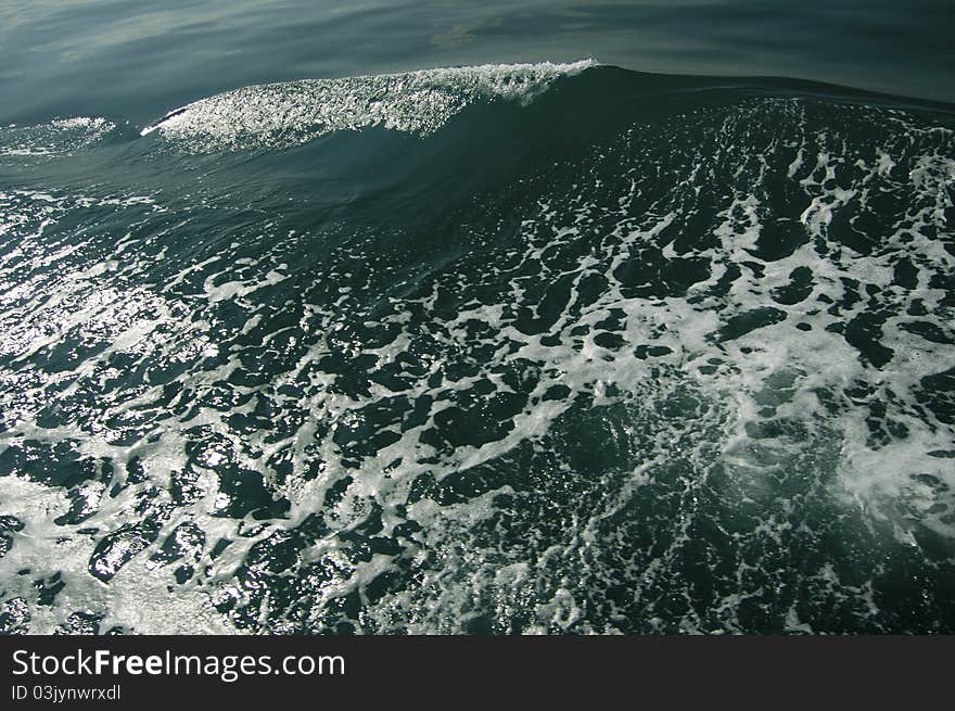 Big marine wave glittering with white bubbles. Big marine wave glittering with white bubbles