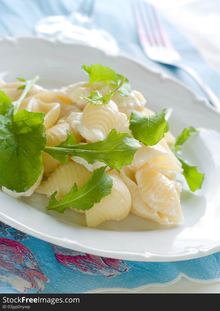 Fresh pasta with arugula and cheese  - selective focus