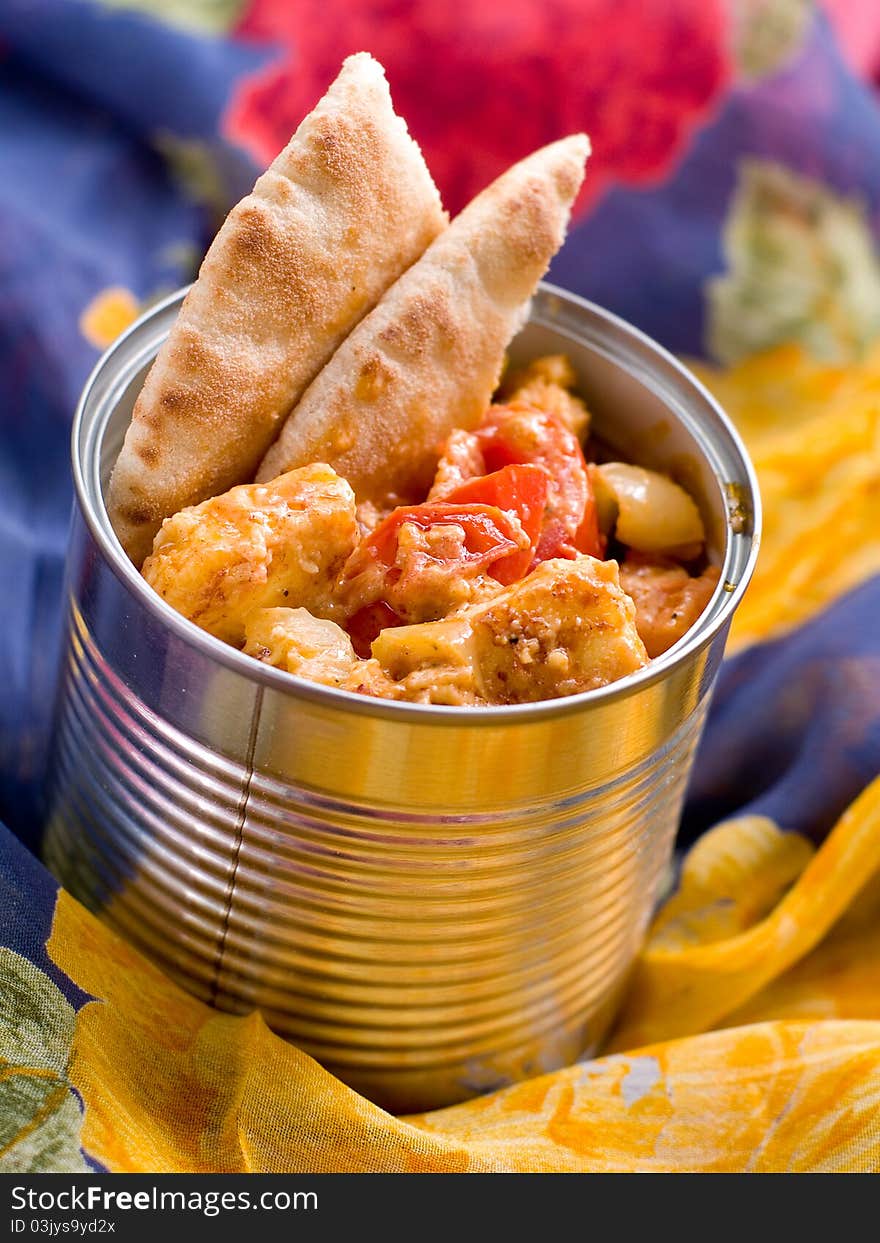 Bowl of spicy curry with cheese and vegetables.  Selective focus; shallow depth of field.