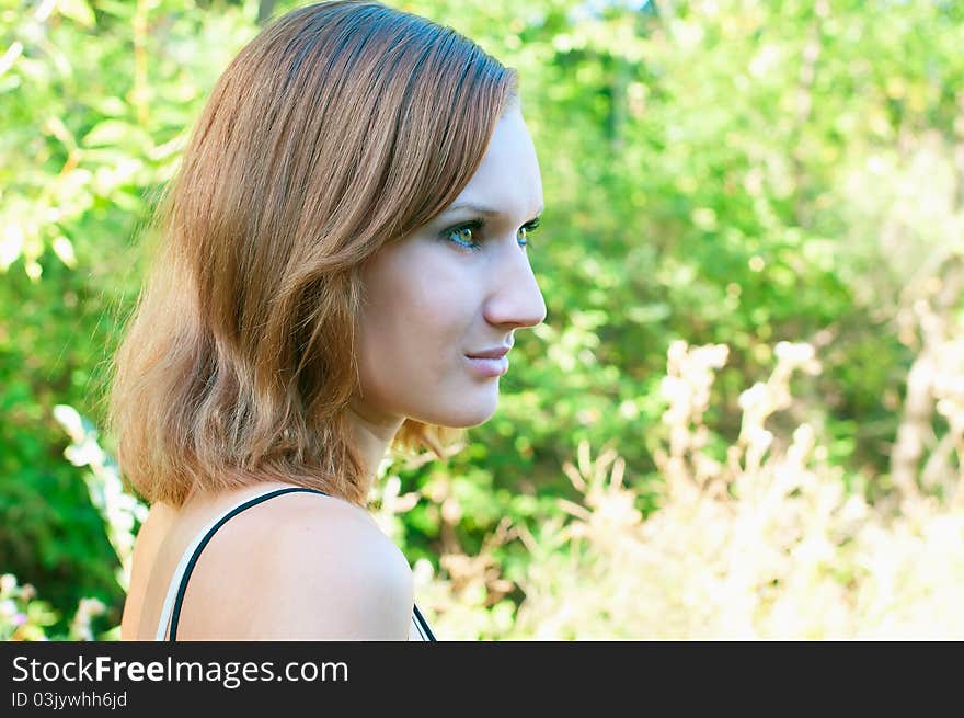 Girl against summer landscape