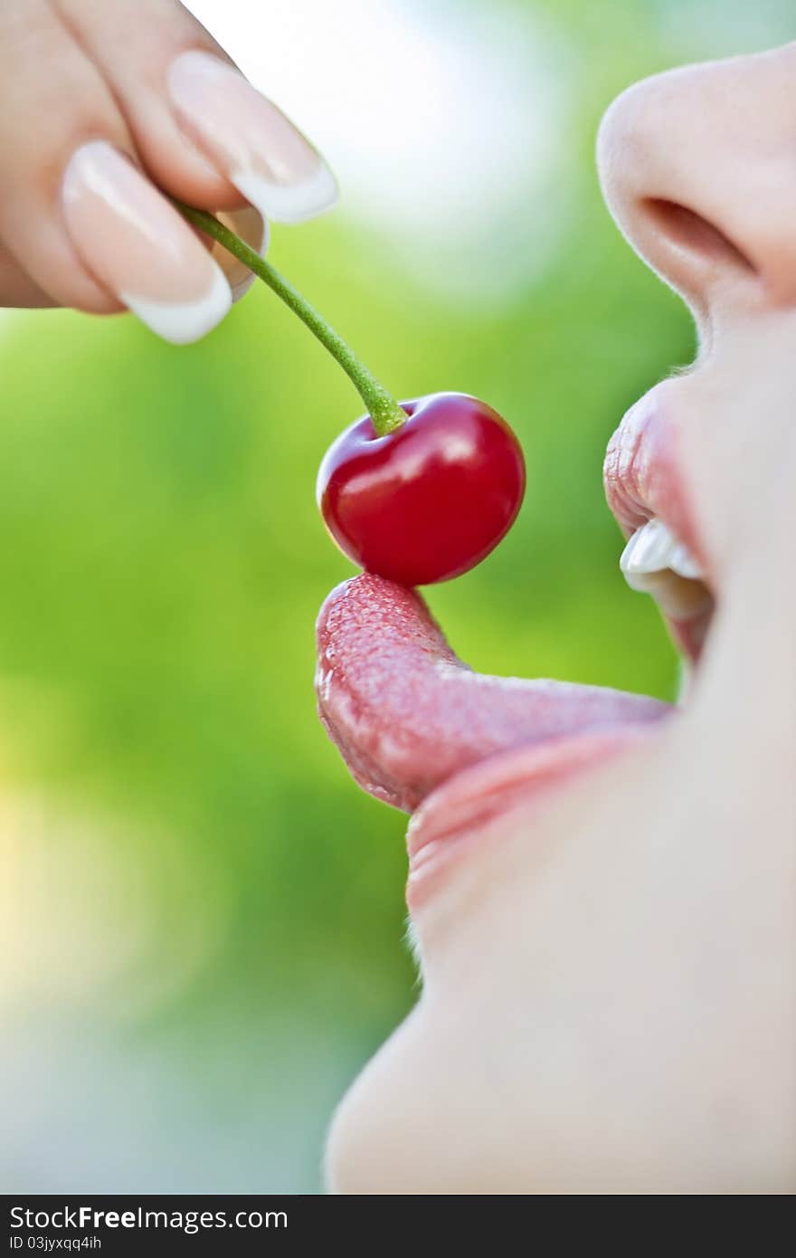 Girl eating  cherry