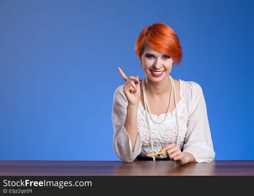 Young beautiful female business executive pointing at copyspace. Young beautiful female business executive pointing at copyspace