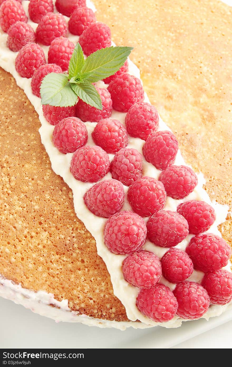 Sponge cake with the cream and the raspberries. Sponge cake with the cream and the raspberries