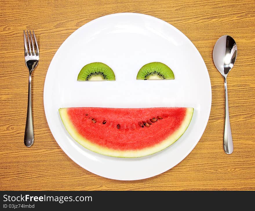 Smile watermelon and kiwi served on white plate. Smile watermelon and kiwi served on white plate